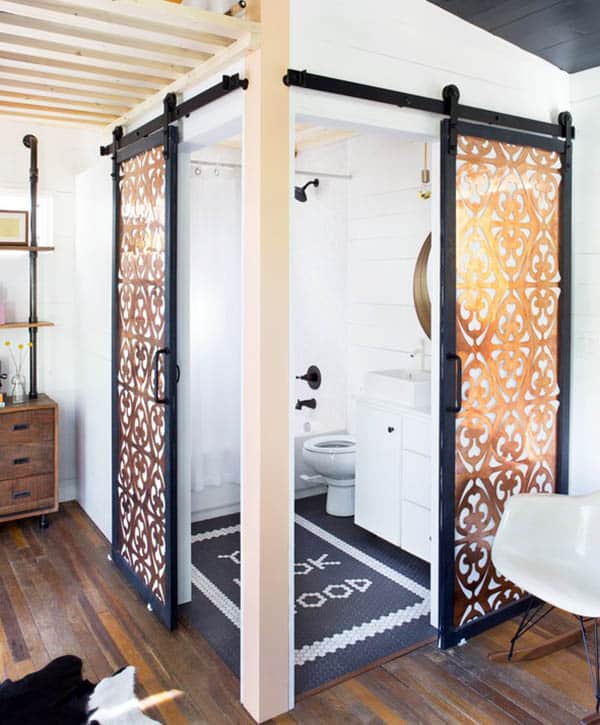 Decorative custom doors, white toilet, and shower room with black accessories