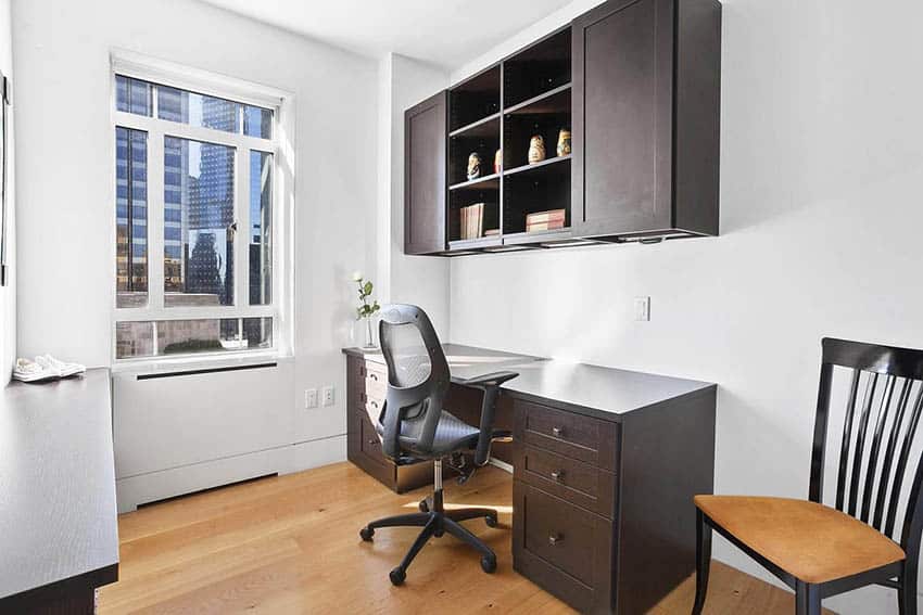 Office with a panel window, dark wood type cabinet and ergonomic chair