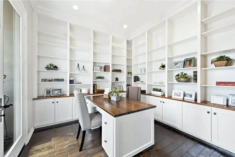 Office with floor to ceiling bookshelves and cabinets