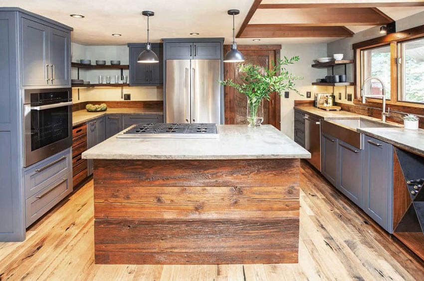 Kitchen with blue gray cabinets, silver hardware and rustic wood island