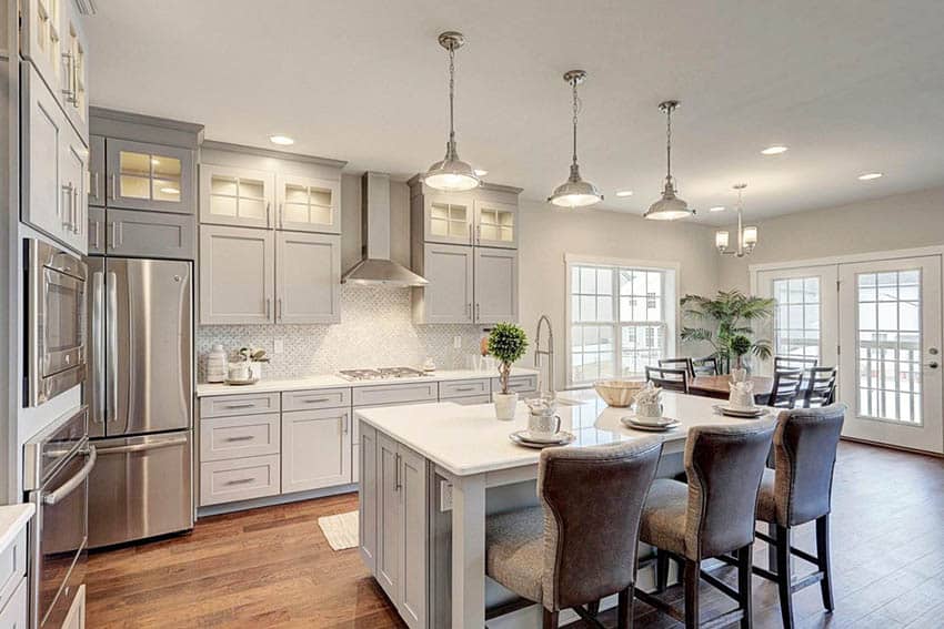 Light gray kitchen cabinets with white counters and french doors