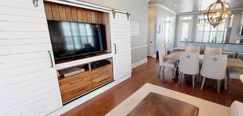 Room with entertainment center with shiplap doors