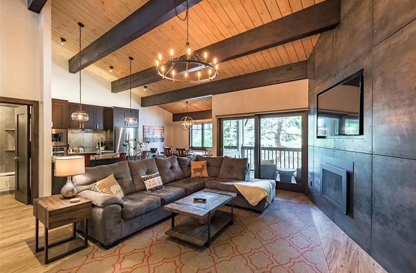 Living room with exposed beam ceiling metal accent wall