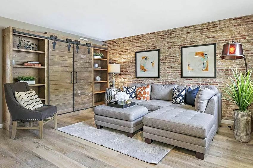 Sectional sofa and entertainment center behind barn doors