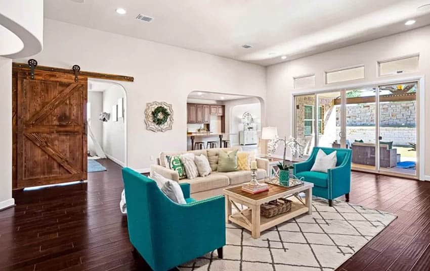 Room with aquamarine chairs, wooden coffee table and white walls