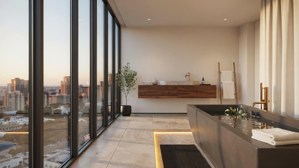 Deep resin soaking tub set against floor to ceiling windows with skyline views