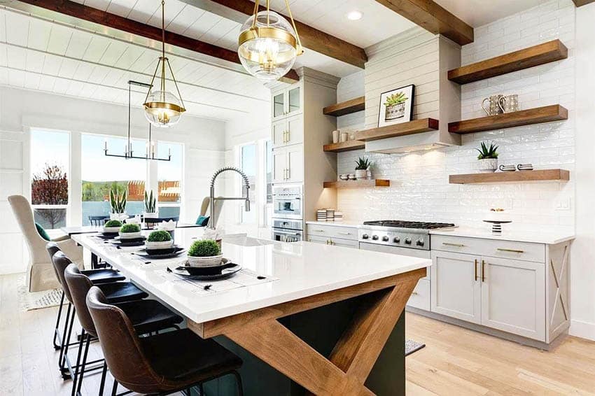 Modern farmhouse kitchen with white cabinets, green island, wood beams, flooring & shiplap ceiling