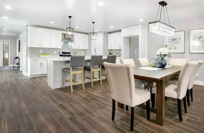 Open concept kitchen and dining room with wood look tile flooring