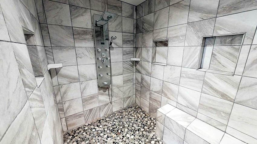 Shower with pebble mosaic tile floor