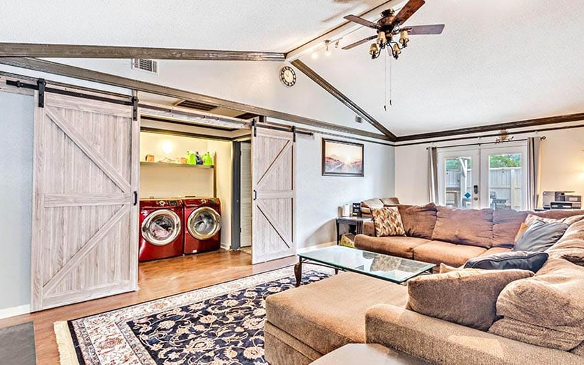 Room with vaulted ceiling, red washing machine, blue walls and carpet