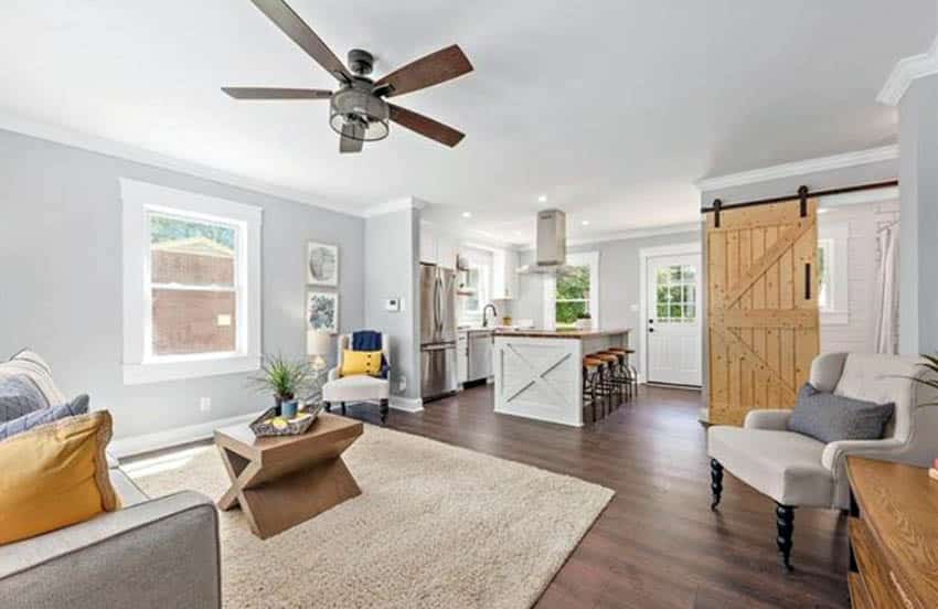 Pine door, beige carpeting, yellow cushions and wooden island