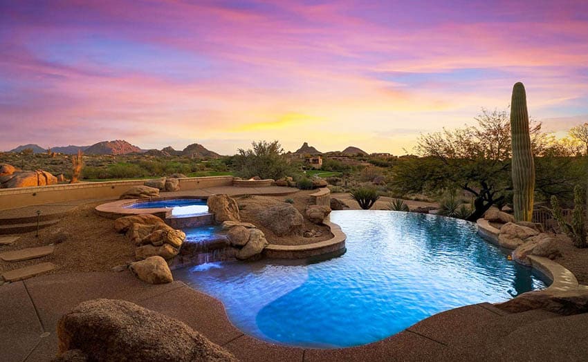 Swimming pool water feature waterfall with desert landscape backyard