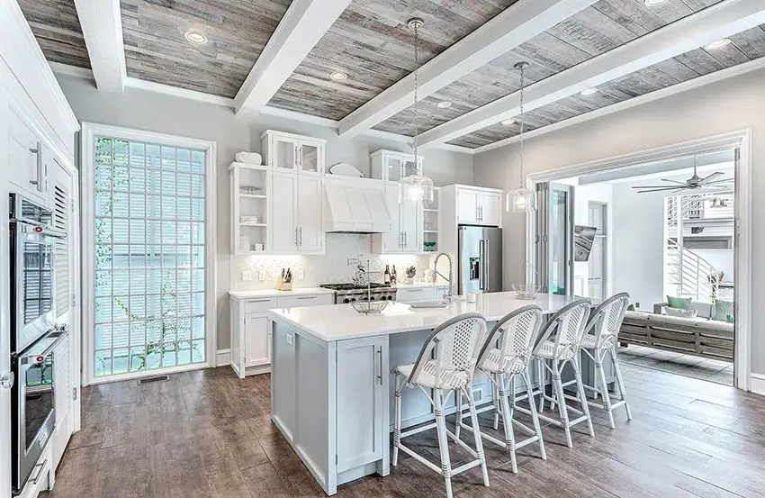 Beautiful kitchen with white cabinets wood plank ceiling and white beams