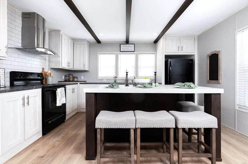 Black and white modern farmhouse kitchen with decorative sign and wood island