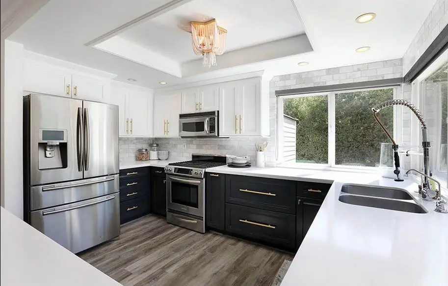 Black and white kitchen with wood laminate flooring