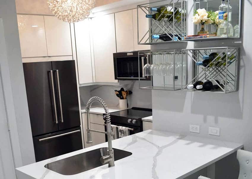 Compact kitchen with cambria quartz countertop white cabinetry