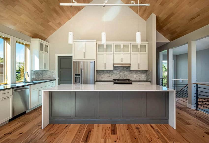 Contemporary kitchen with tongue and groove plank cathedral ceiling and pendant lights