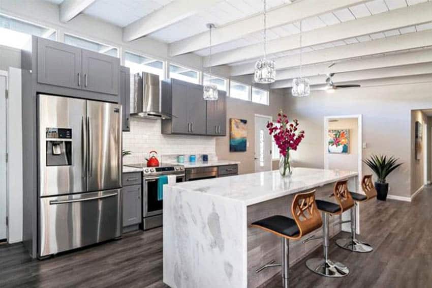 Contemporary kitchen with white plank ceiling quartz counter island