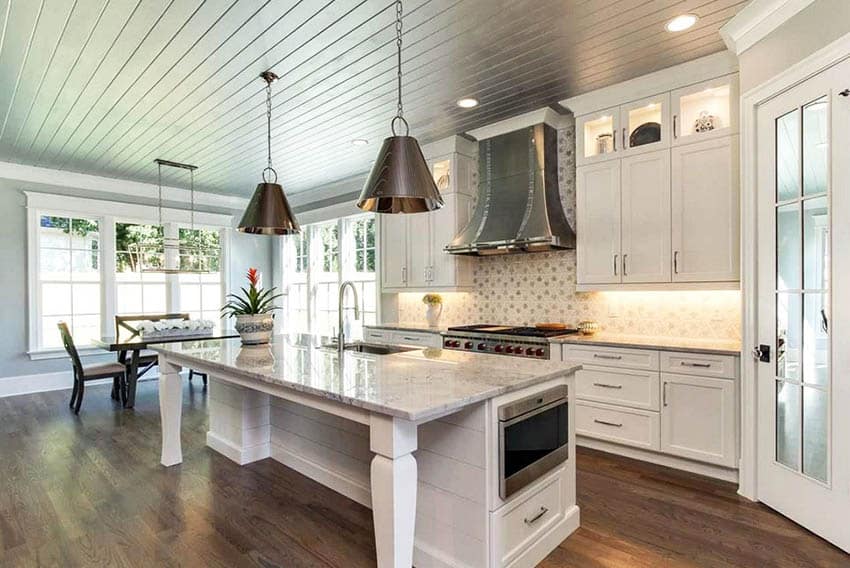 Contemporary kitchen with wood tongue and groove ceiling white cabinets wood flooring