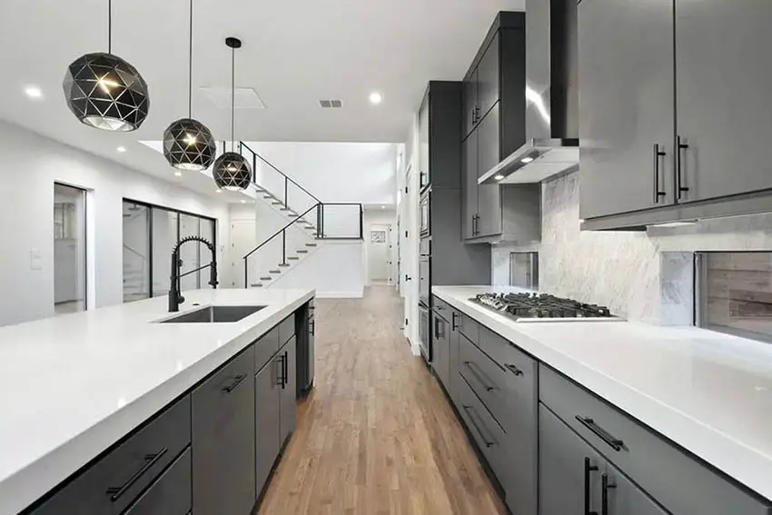 Galley style kitchen with black cabinets white quartz counters