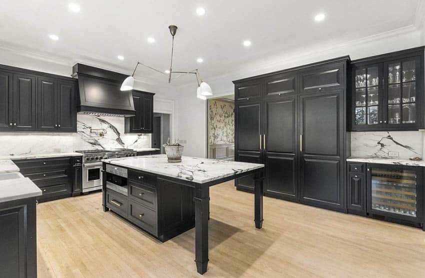 Kitchen with black cabinets white quartz countertops and backsplash