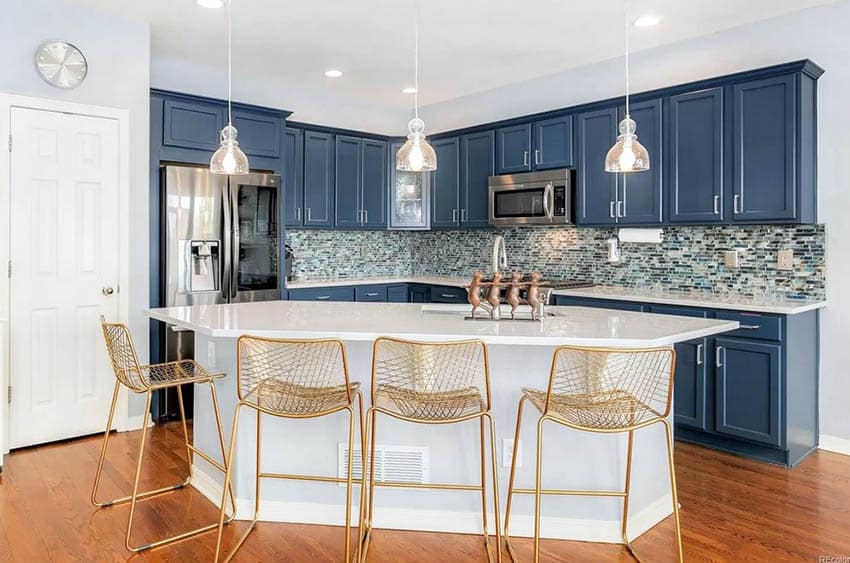 Kitchen with blue cabinets white island and cambria quartz countertops