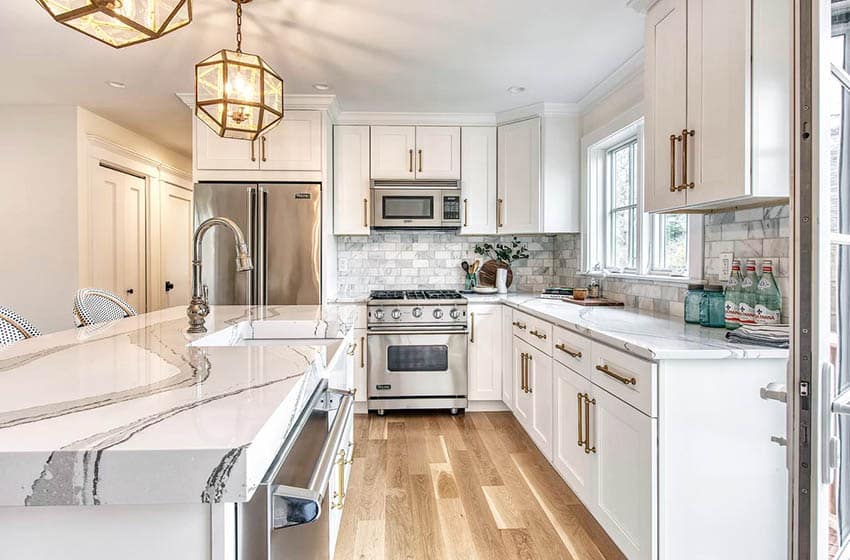 Kitchen with brittanicca cambria quartz countertops white cabinets marble backsplash