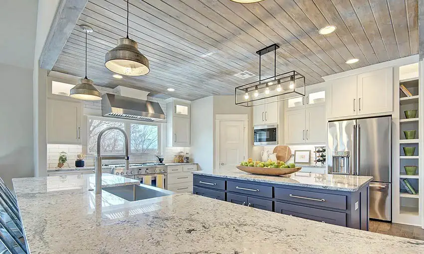 Kitchen with tongue and groove wood ceiling white cabinets blue island
