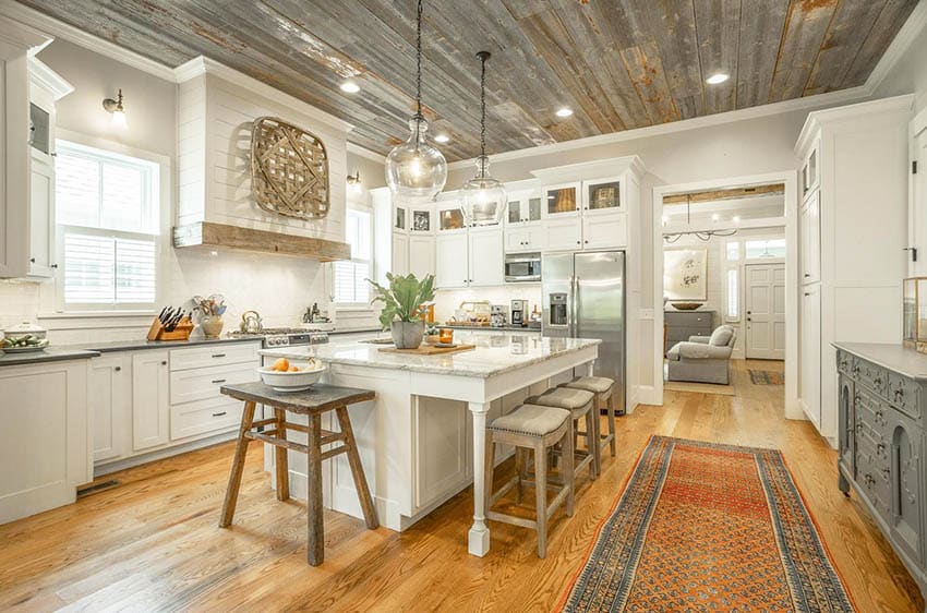 Kitchen with wood ceiling white cabinets shiplap oven hood