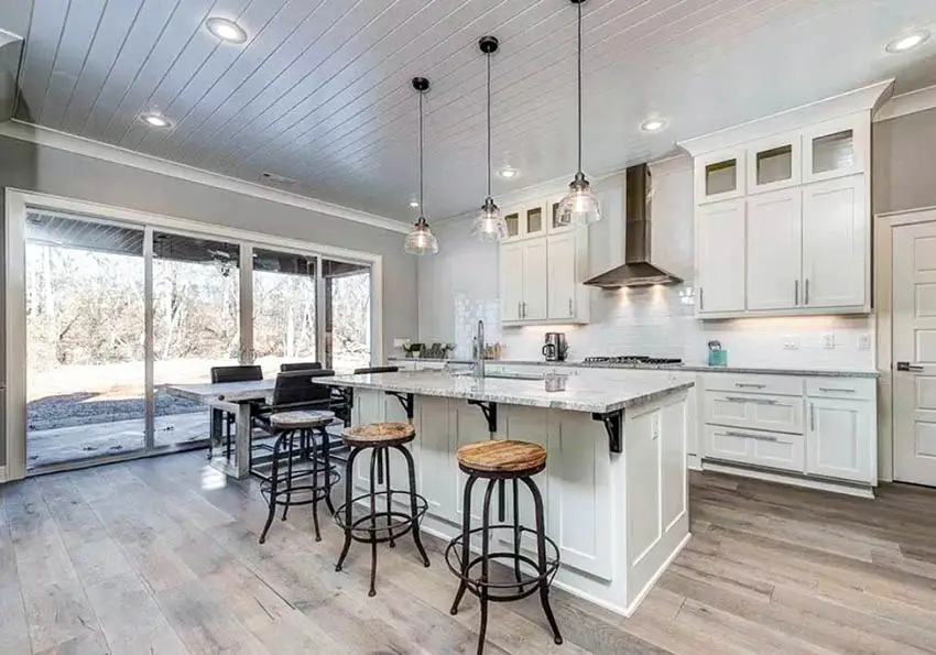Kitchen with wood painted white tongue and groove ceiling