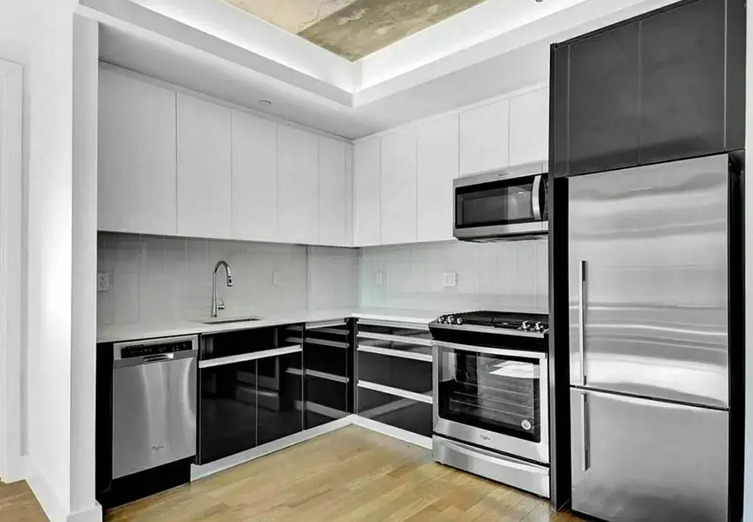 Modern corner kitchen with black and white cabinets