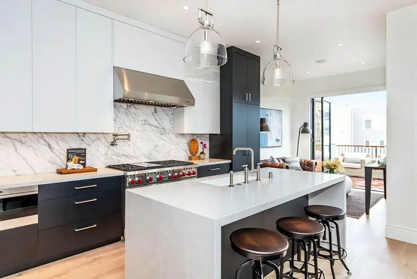 Modern kitchen with black lower cabinets and white upper cabinets with quartz backsplash