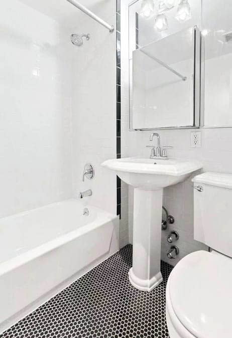 Small bathroom with black penny floors with white grout