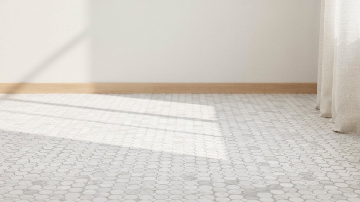 Soft white porcelain penny tile floor with fine even grout lines throughout
