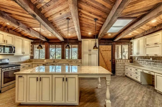 Rustic Kitchen With Wood Plank Ceiling And Distressed Cabinetry 640x425 