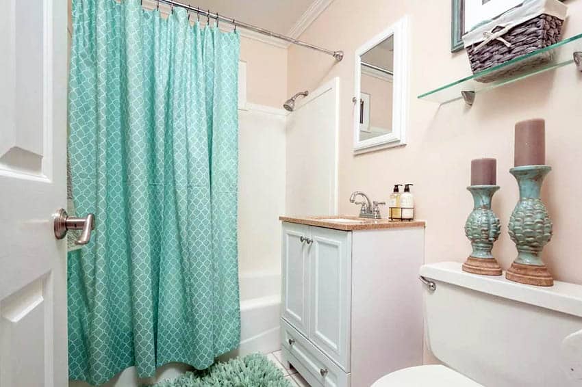 Shower with green curtain white vanity