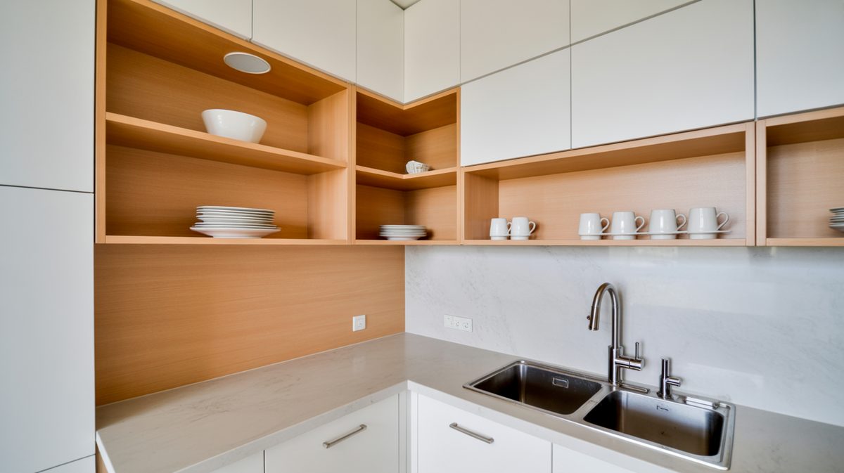 Small kitchen with black pantry and industrial pipe shelves by window