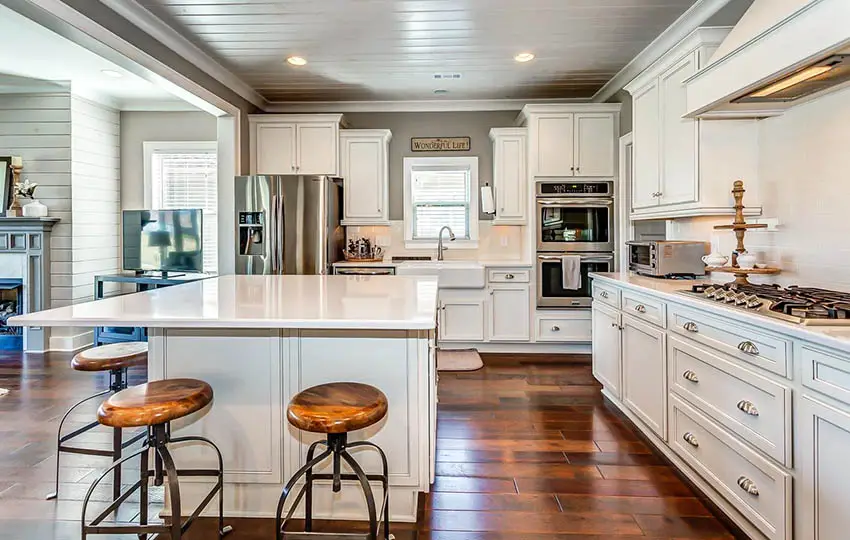 White kitchen with wood plank ceiling and wood tile flooring