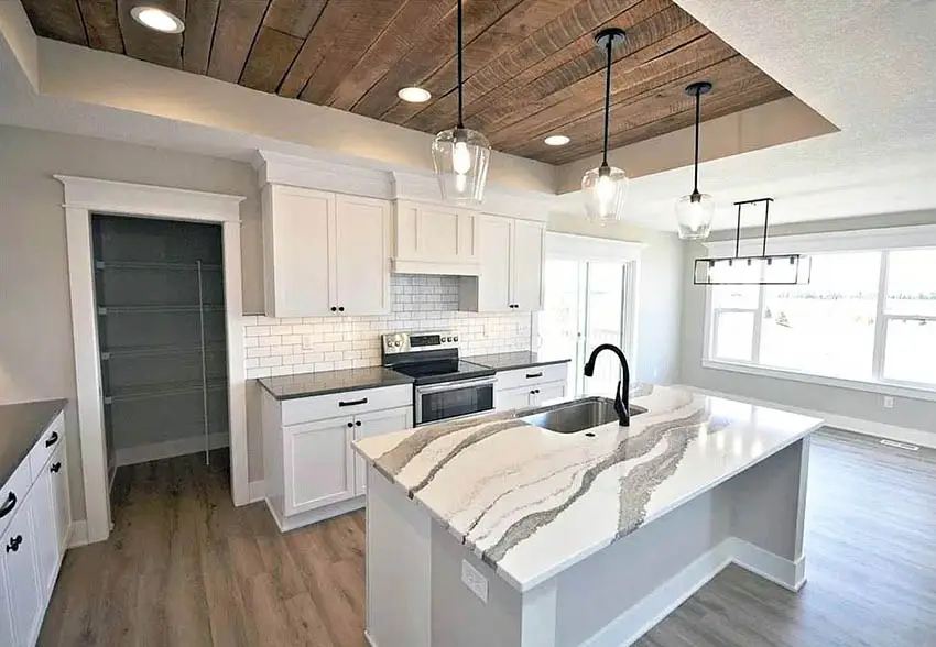 White kitchen with rough plank accent ceiling