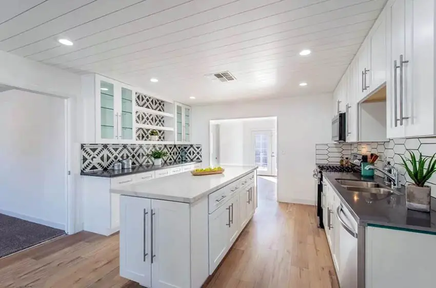White kitchen with wood ceiling