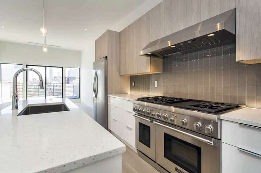 Contemporary kitchen with stainless steel range hood