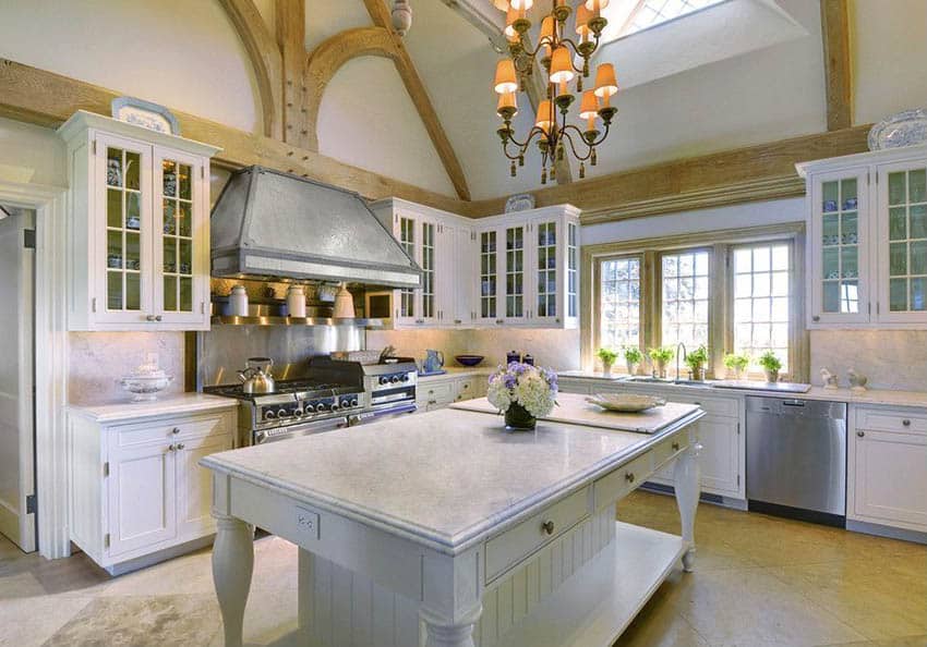 Country kitchen with picture frame window, row of plants and carrara marble countertops