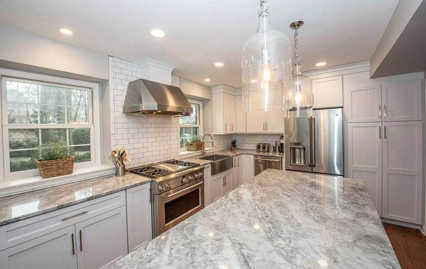 Kitchen with subway tile, window sill with plants