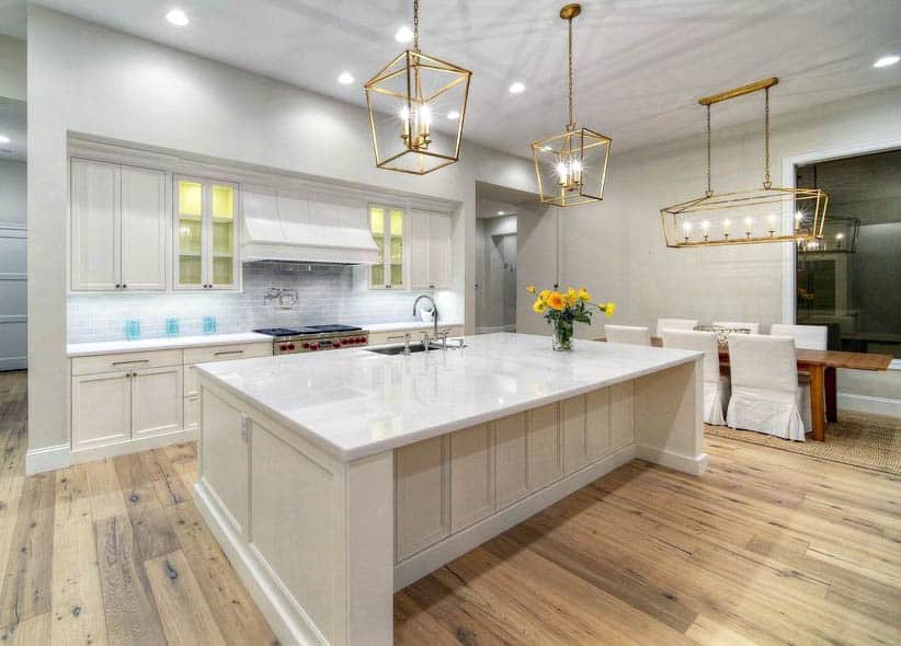 kitchen-with-beige-cabinets-white-quartz-countertop-gold-finish-hardware