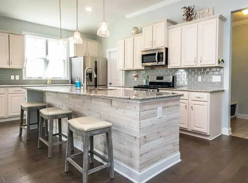 kitchen-with-beige-cabinets-wood-island-glass-backsplash