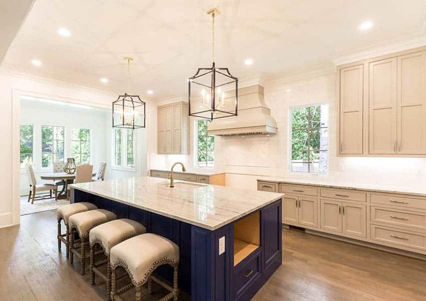 Contemporary kitchen with beige cabinets, dark blue island and quartz countertops