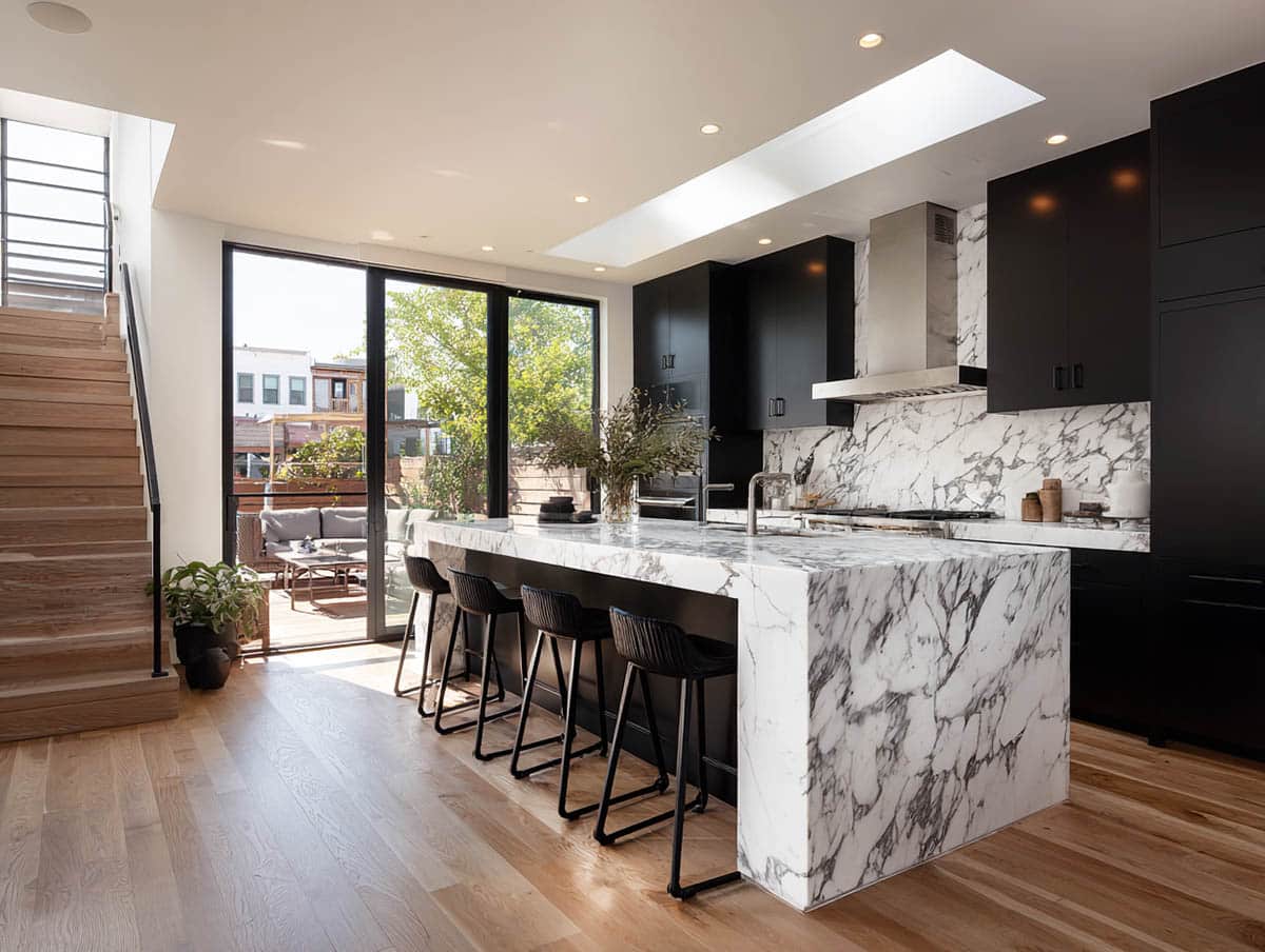 Luxury kitchen with marble slab backsplash and island