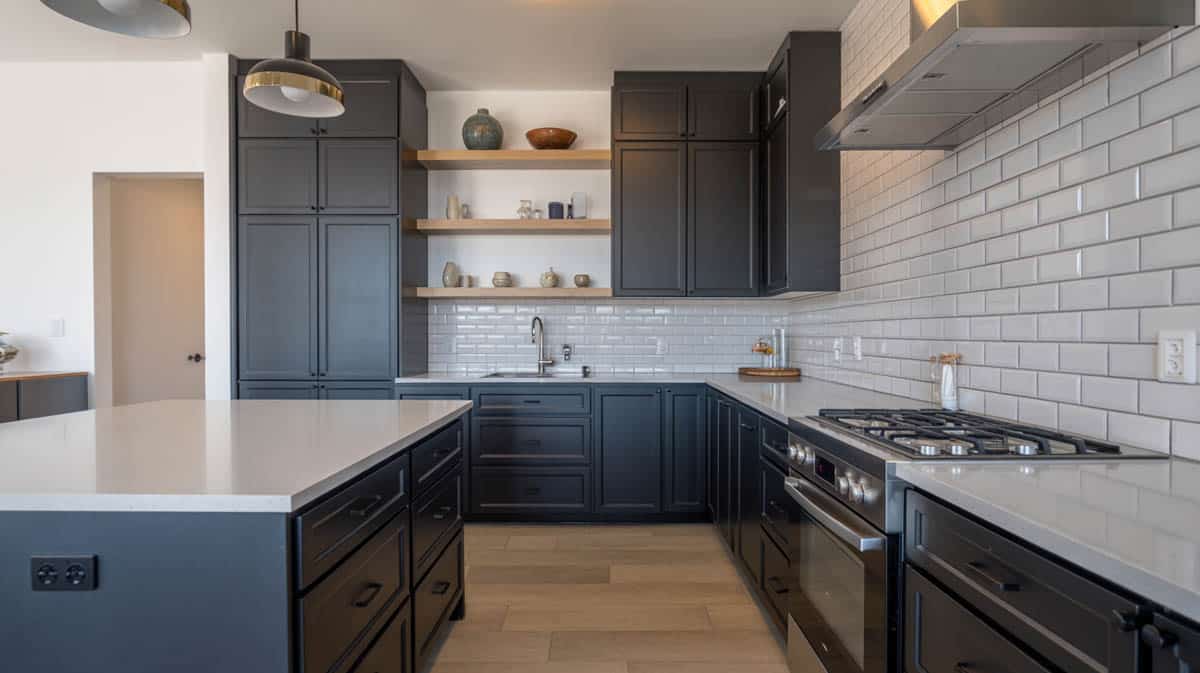 Contemporary black-cabinet kitchen with white quartz counters, subway tile and open shelving