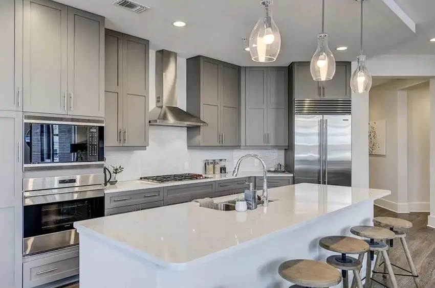Contemporary kitchen with gray cabinets, white quartz counters and white island