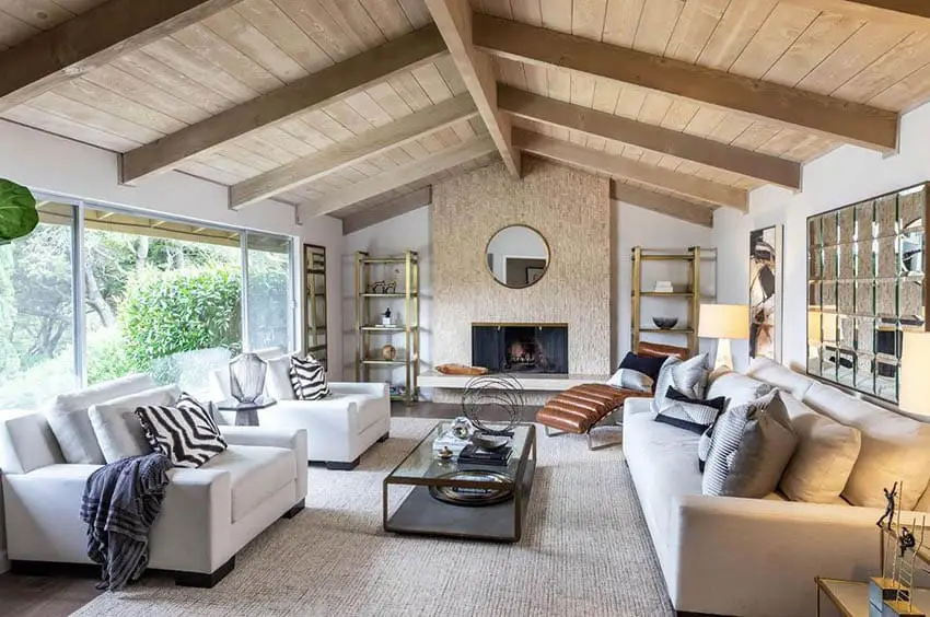 Contemporary living room with wood cathedral ceiling and beige accent wall fireplace